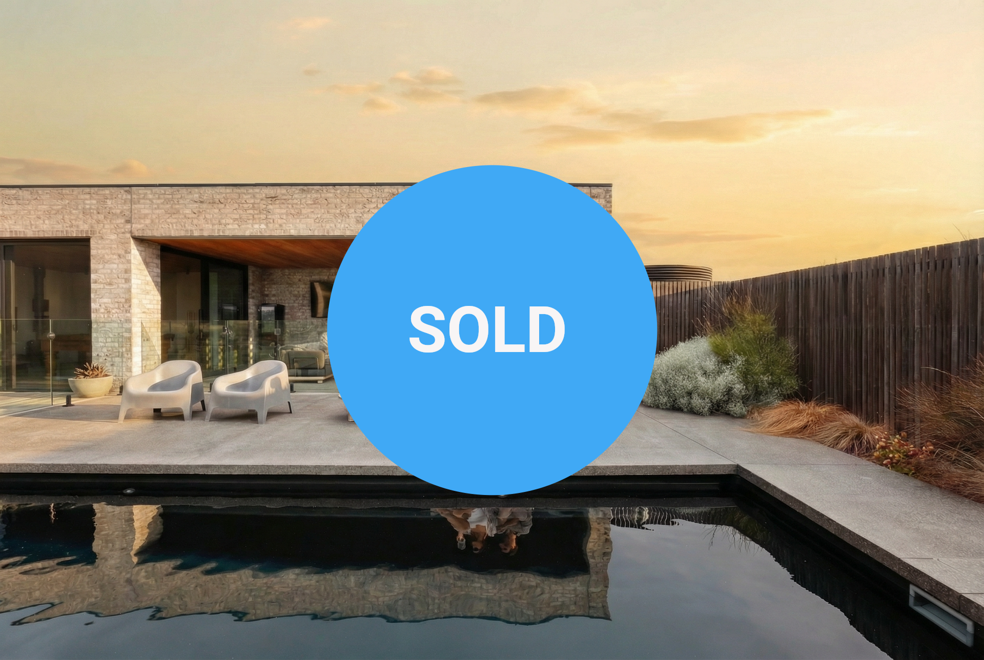 An aerial view of a large house with a view of the ocean.