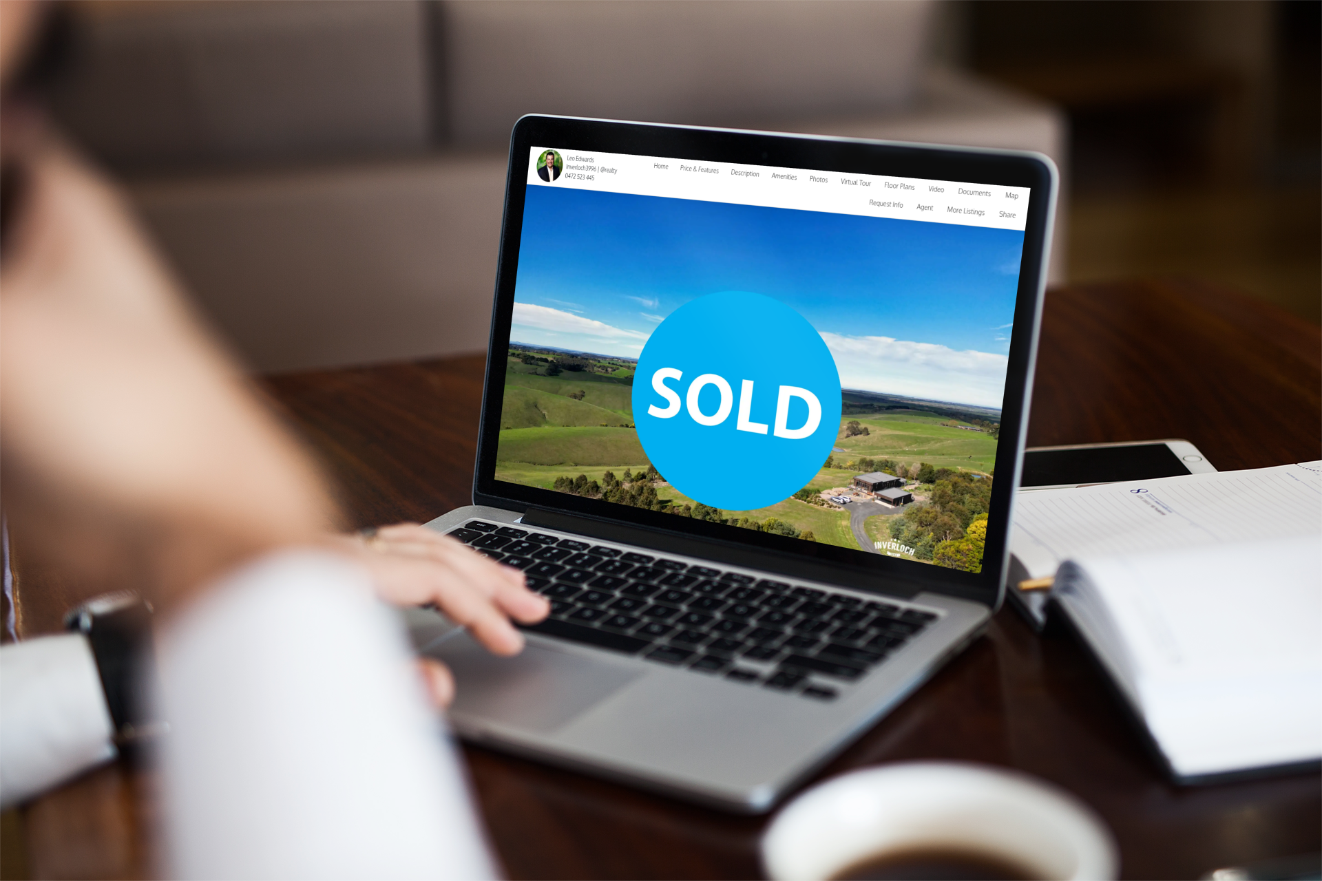 Person using laptop, real estate website with 