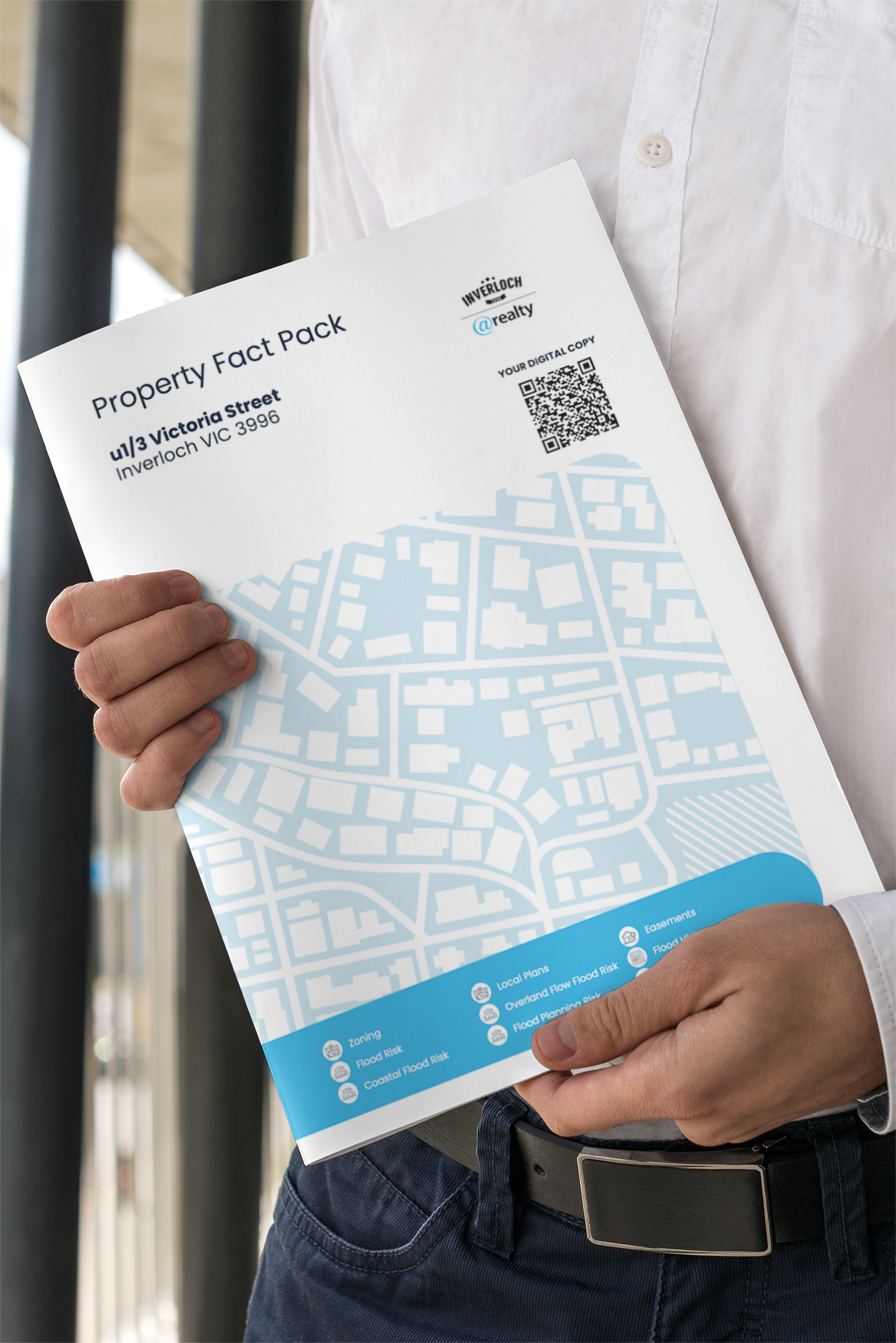 Person holding a white brochure with a blue map and QR code.