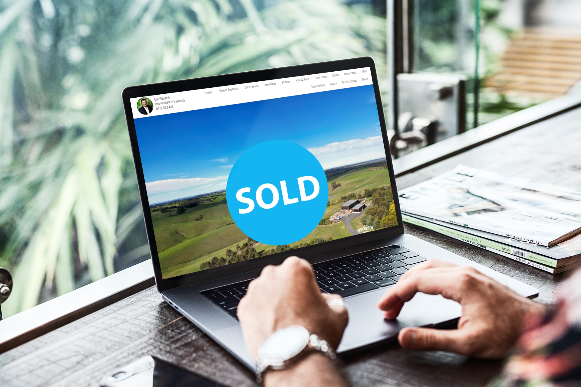 Laptop displaying a sold property listing. Person at a desk views the listing.