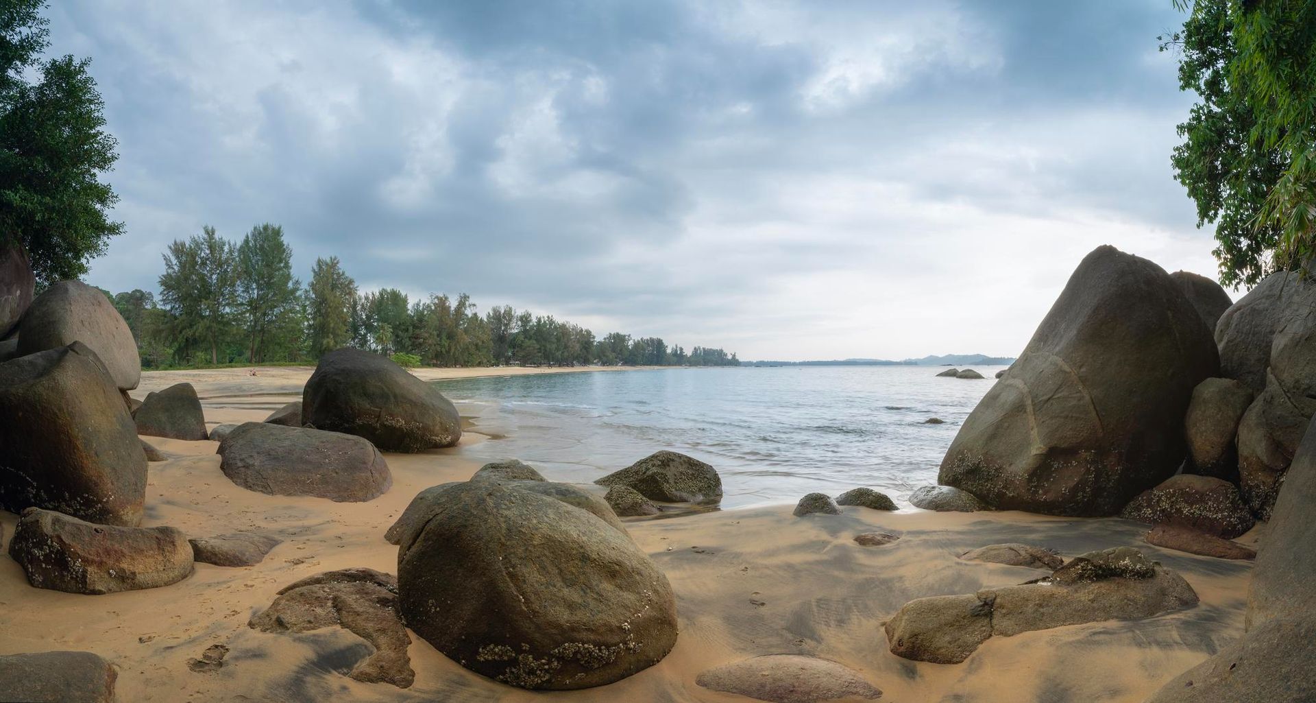 A rocky beach with a large body of water in the background