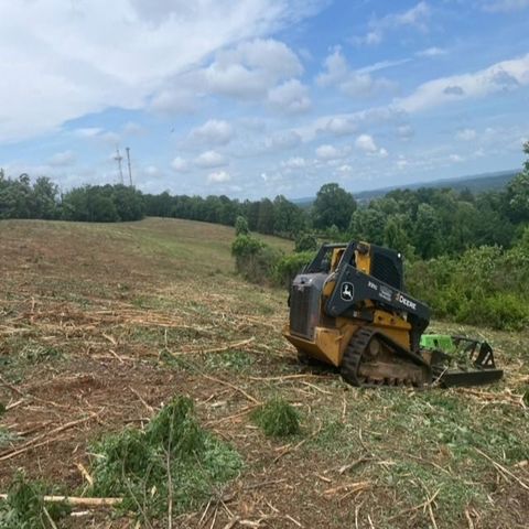 A bulldozer is working on a dirt road