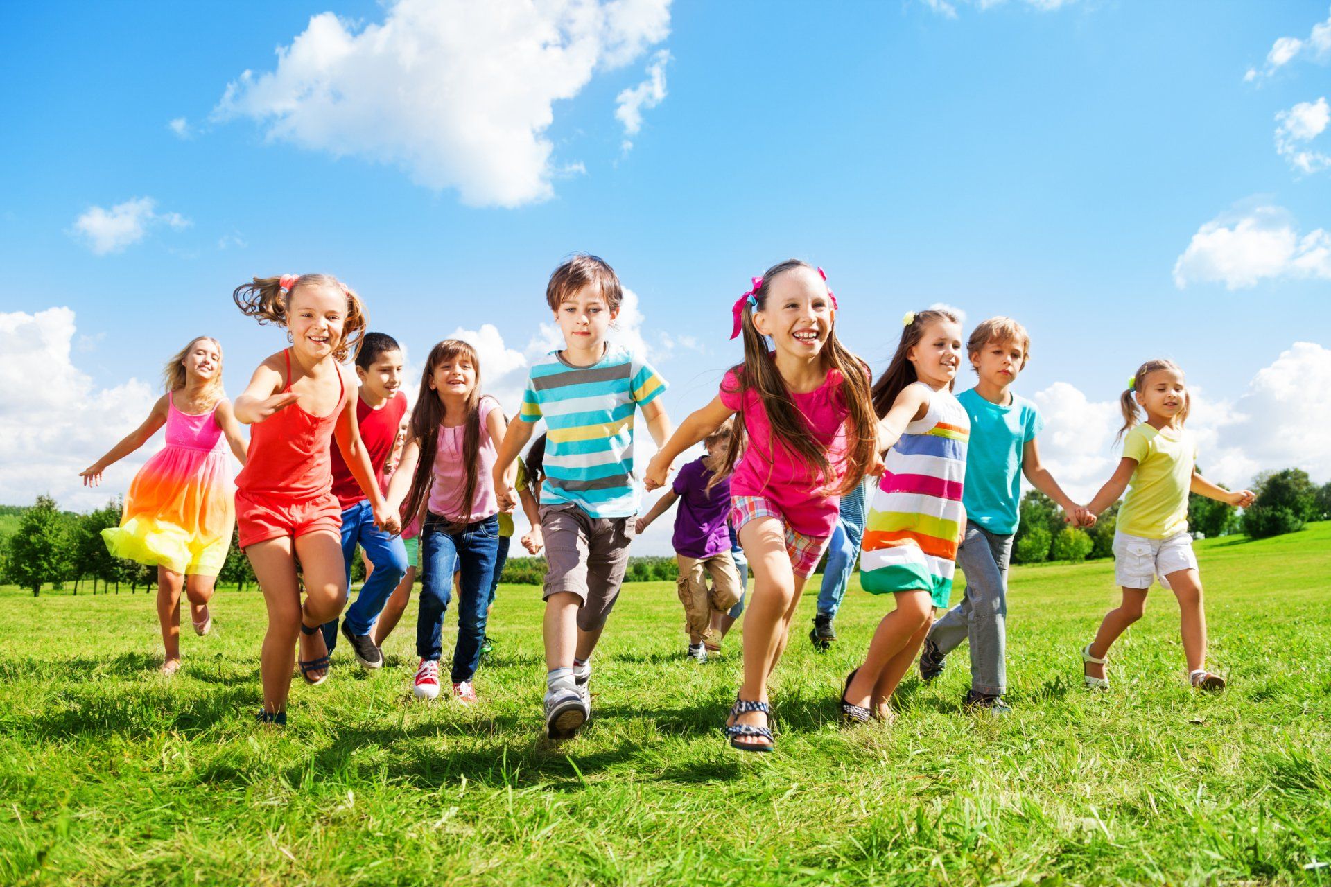 Montessori Admissions — Group Of Kids Running Over Grass On A Sunny Day in Glenshaw, PA