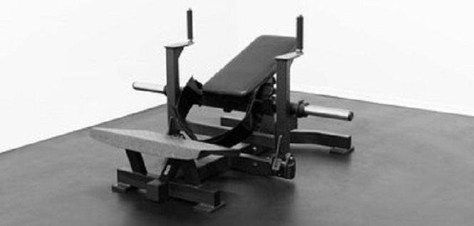 Weightlifting equipment: bench press machine on a dark surface.