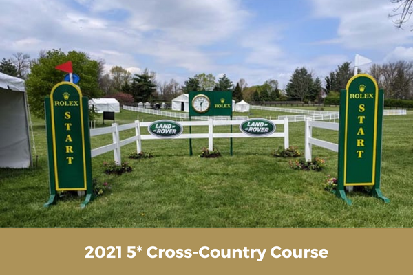 A picture of a cross country course with a white fence.