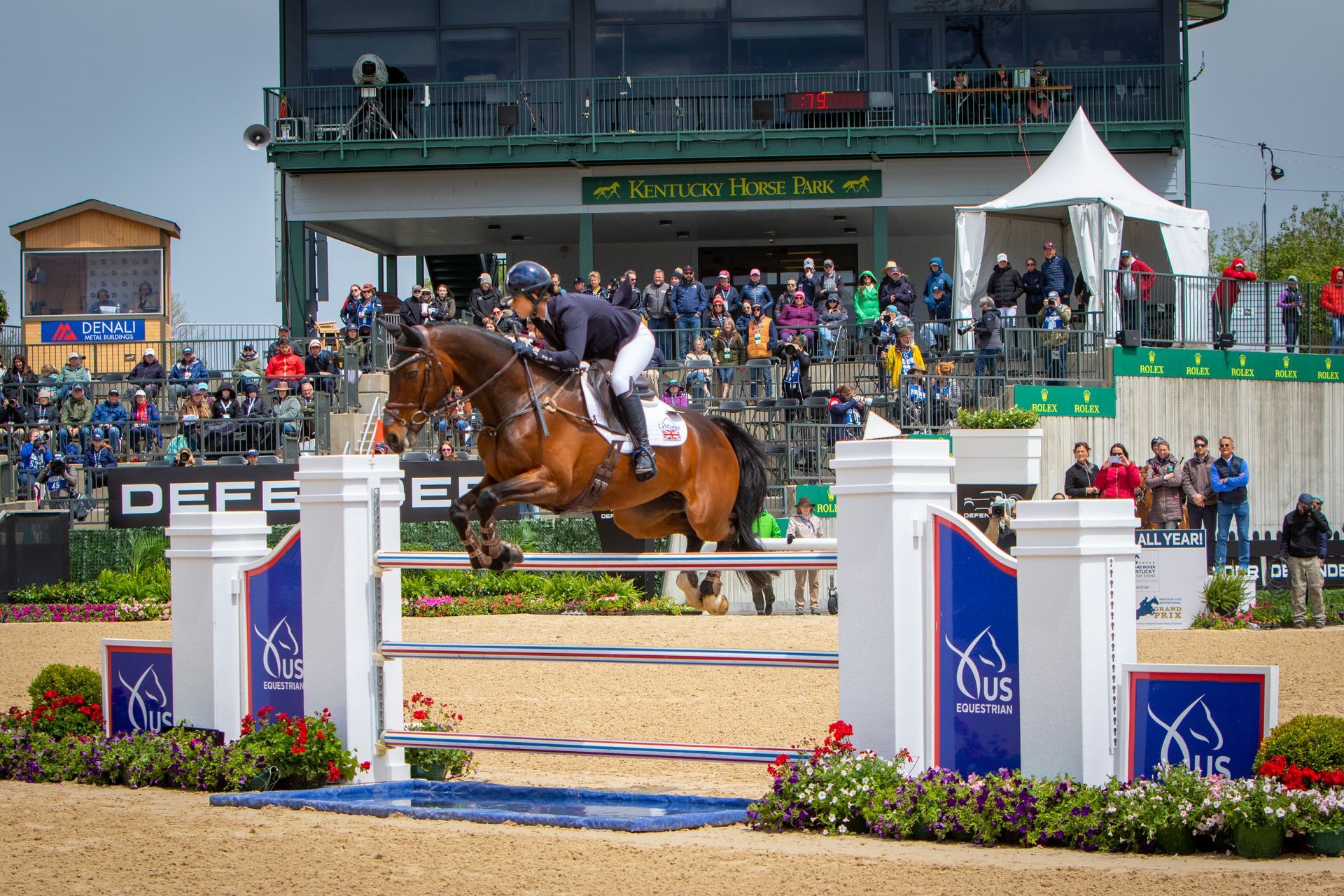 A rider and horse soar over a showjumping obstacle at the Kentucky Horse Park during the K3DE.