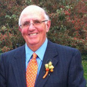 A man in a suit and tie is smiling for the camera.