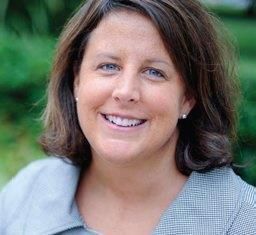 A close up of a woman 's face smiling for the camera.