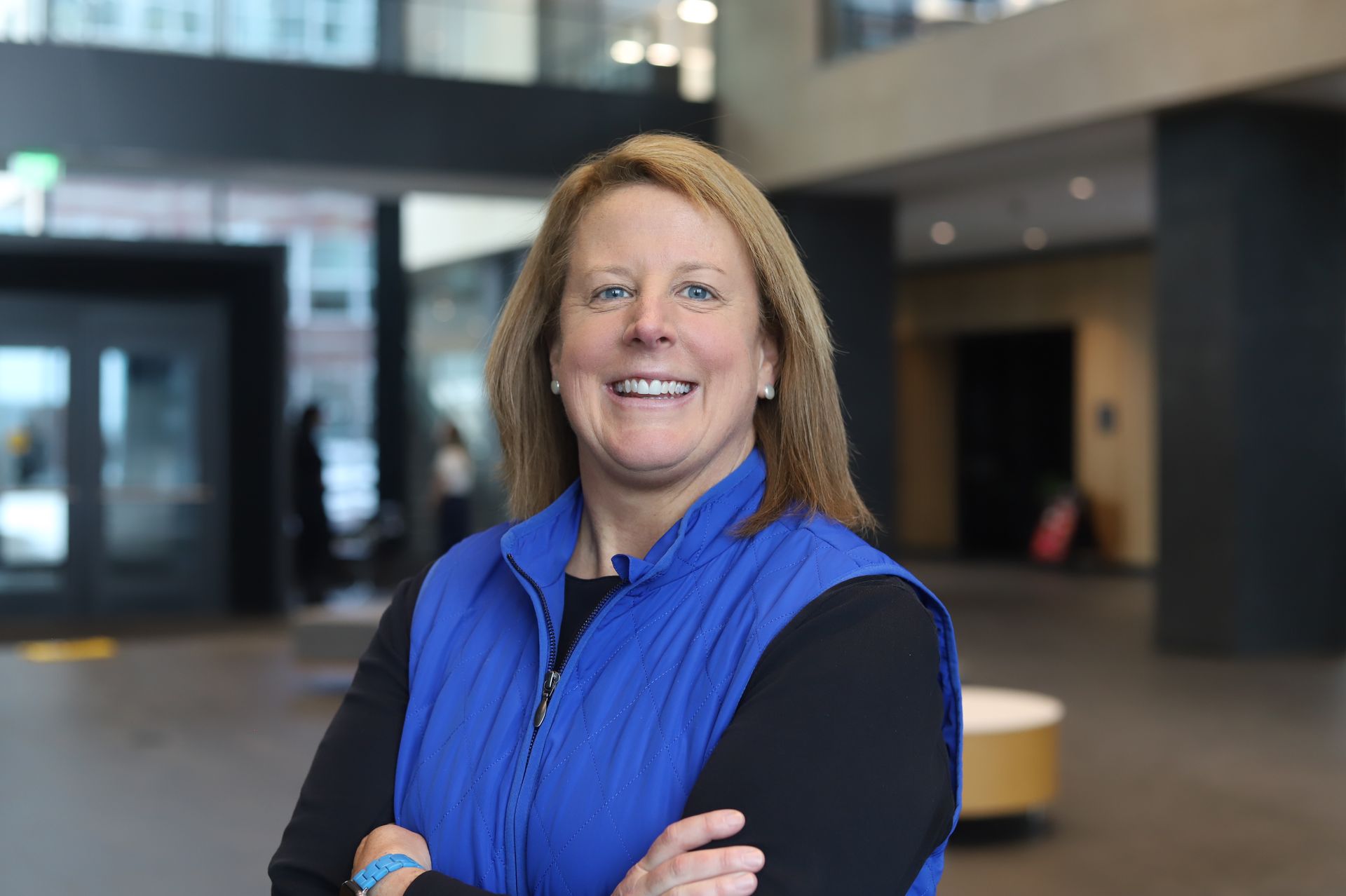 A close up of a woman 's face smiling for the camera.