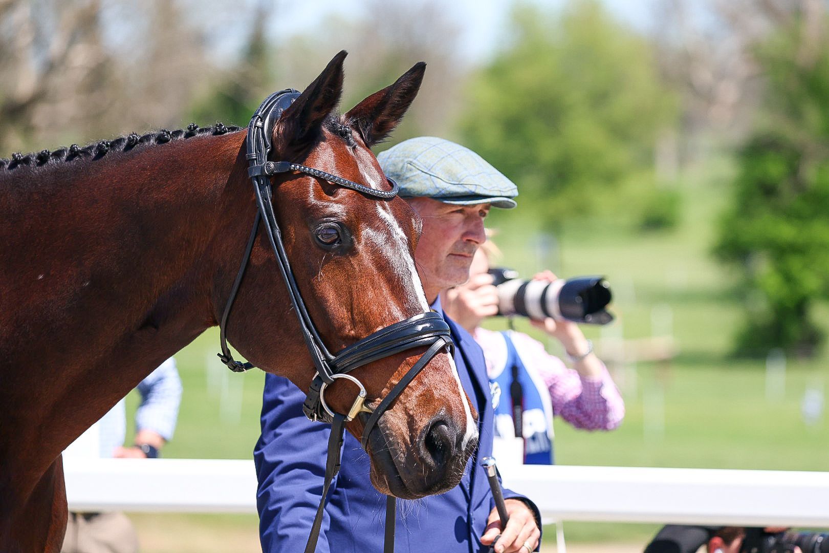 A man smiles next to a horse