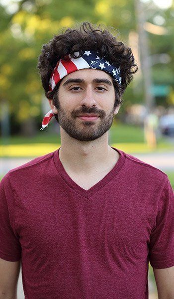 A man wearing an american flag bandana on his head