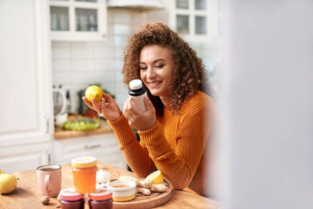 Woman Smiling At Supplements — Hampden, ME — Baker Family Chiropractic