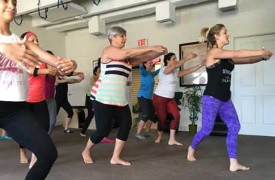 A group of women are dancing in a room.