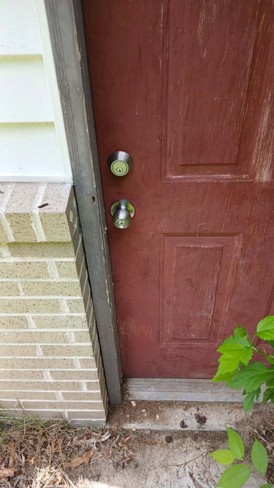 A close up of a door lock with keys in it
