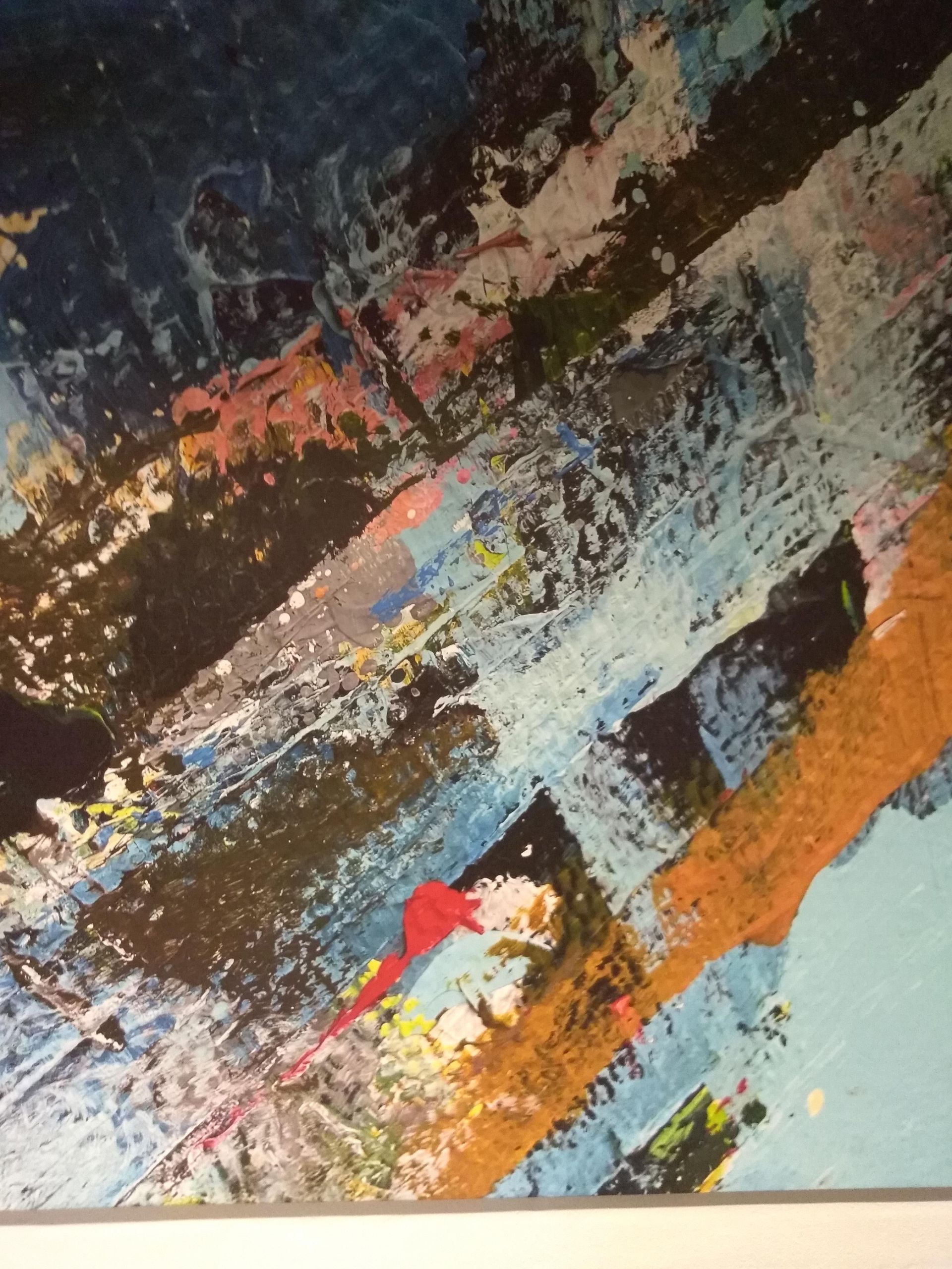 Abstract graffiti art in orange, black, and pink with visible scratches.