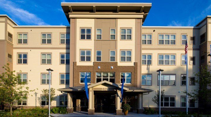 A large building with a blue flag in front of it