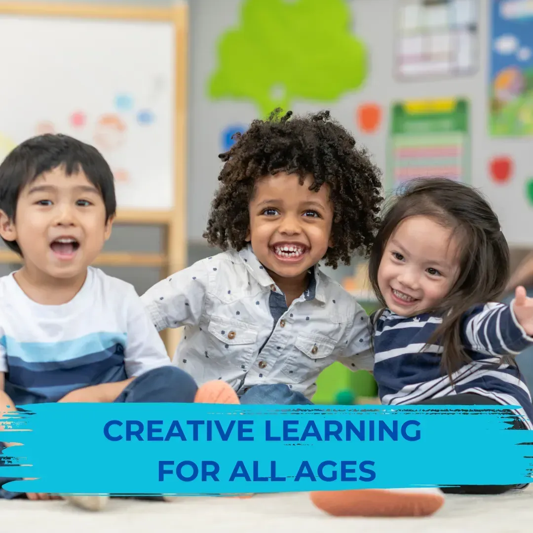 A group of children are sitting on the floor with a sign that says creative learning for all ages.
