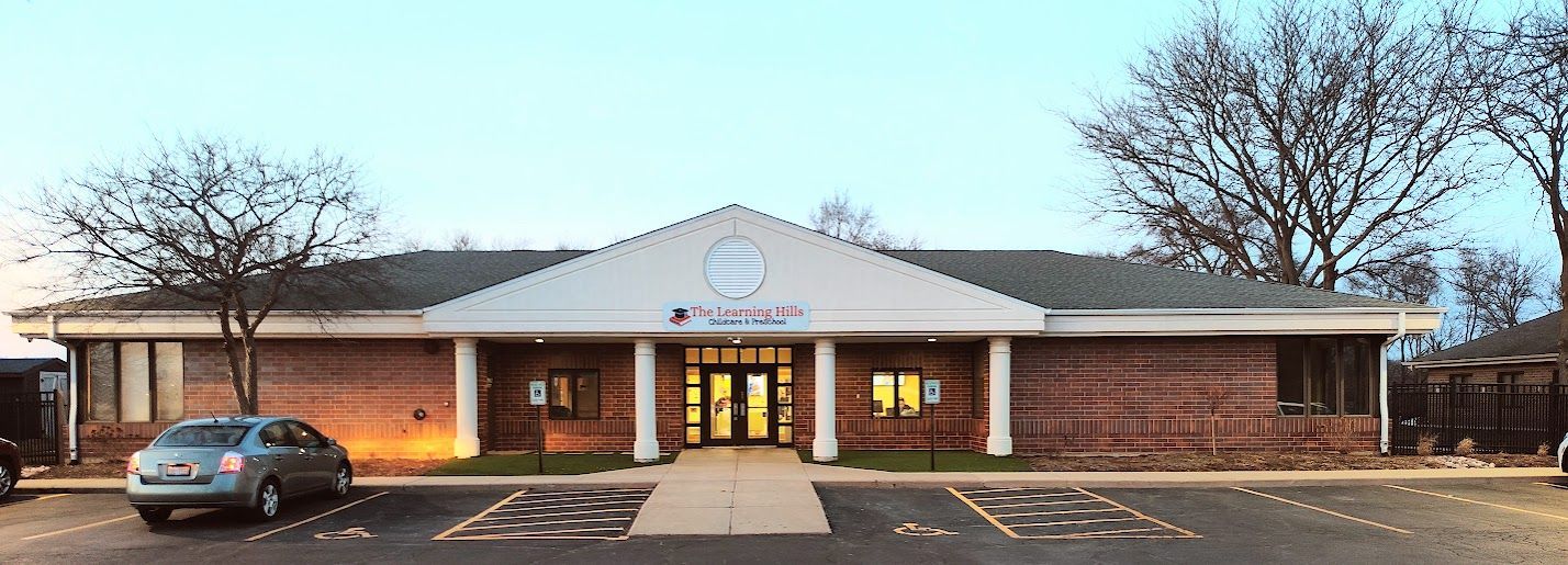 A brick building with a car parked in front of it.