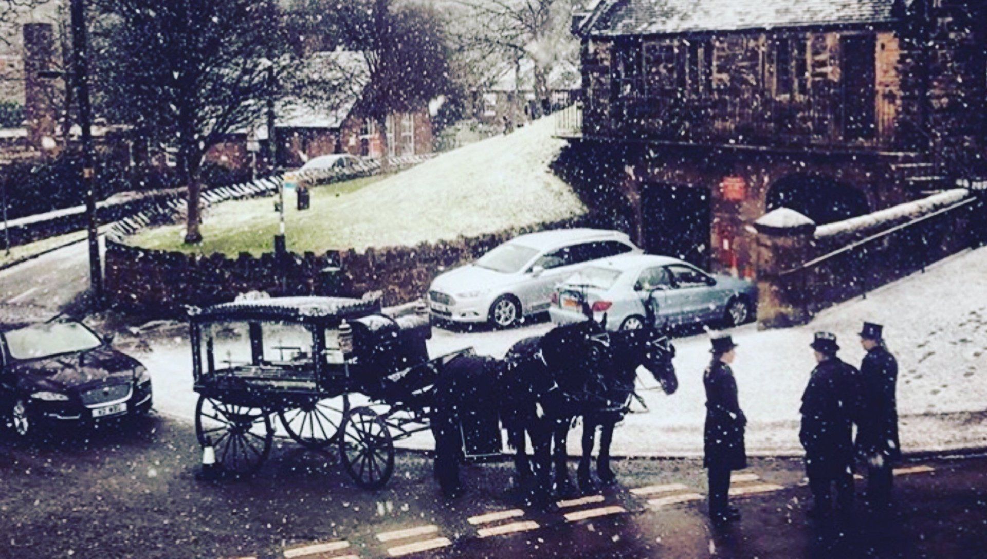 black horse-drawn hearses