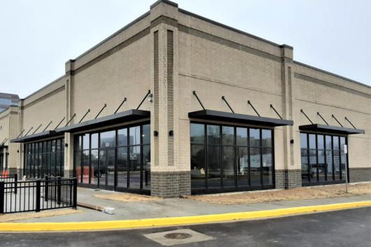 A building with a lot of windows and a yellow curb