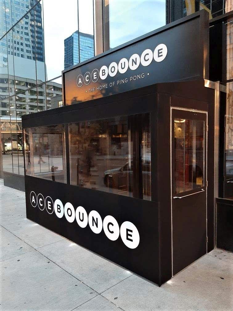 A black building with a sign that says acebounce on it