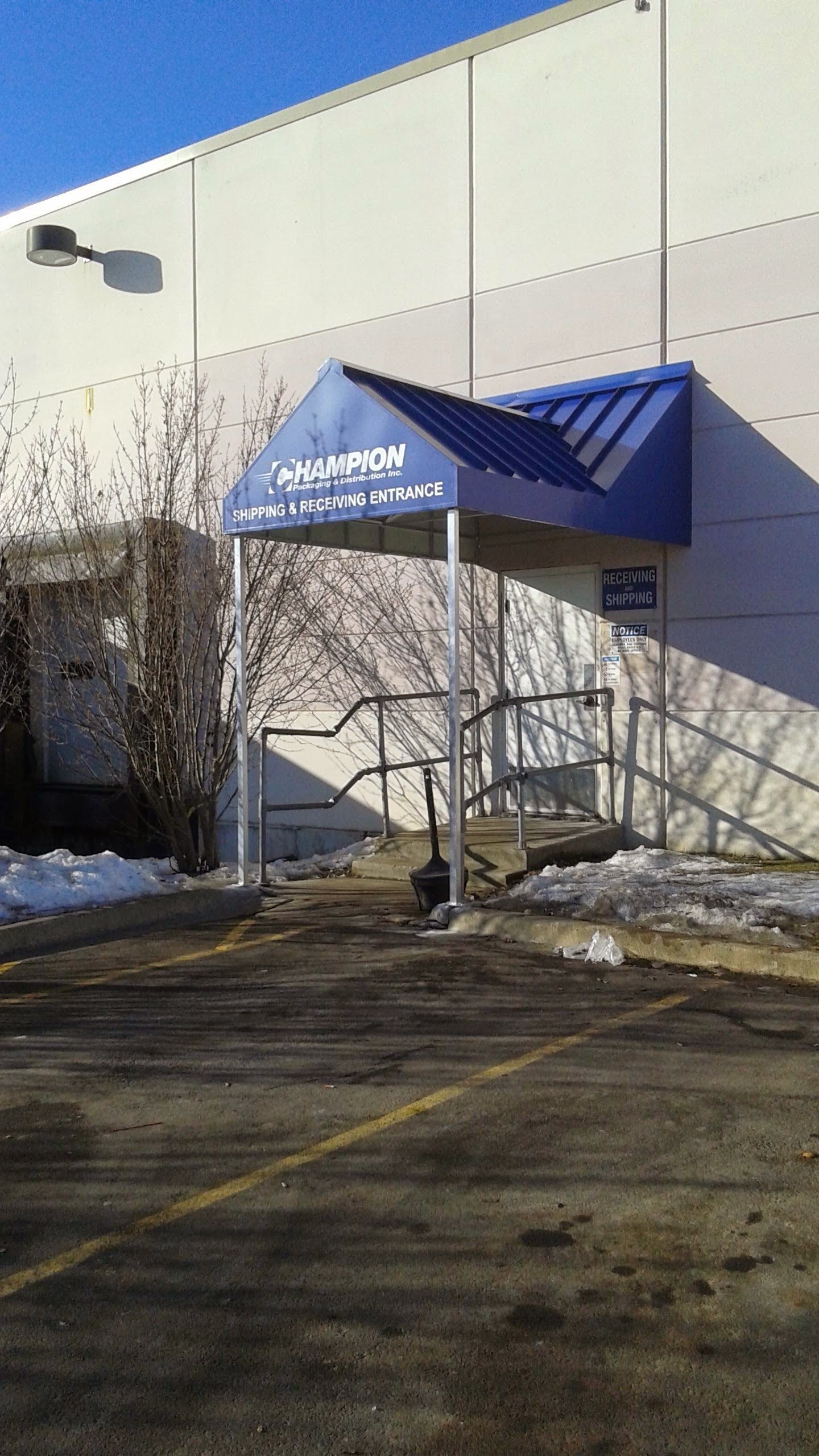 A building with a blue awning over the entrance