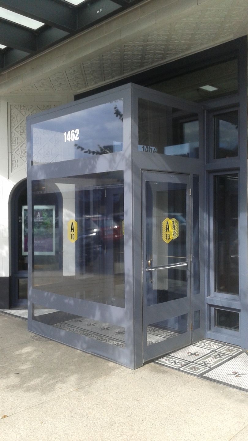 A building with a glass door and a sign that says 1482