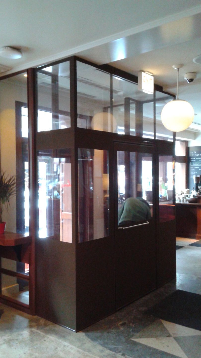 A room with a lot of windows and a glass wall.