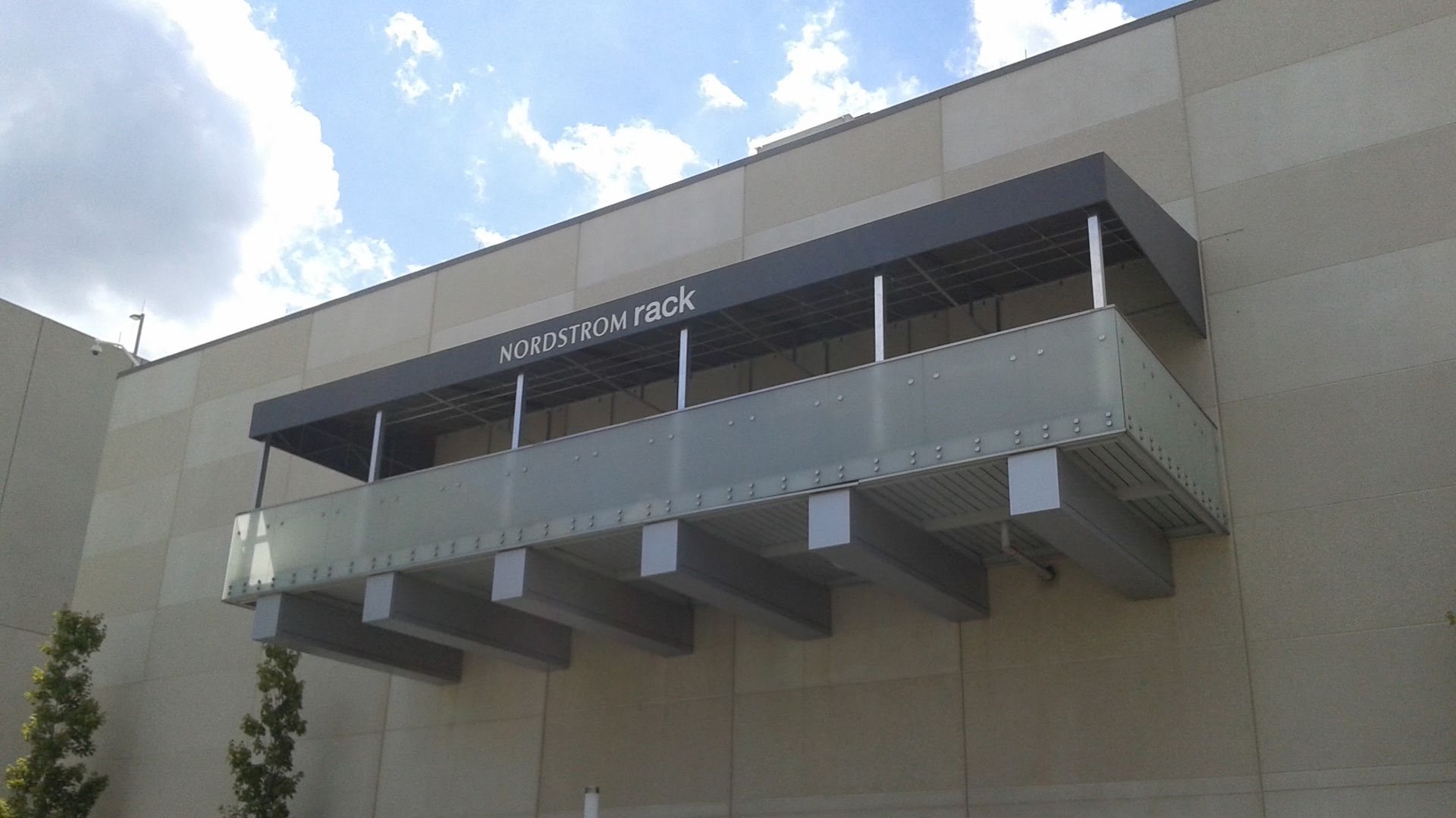 A balcony on the side of a building with a canopy over it.