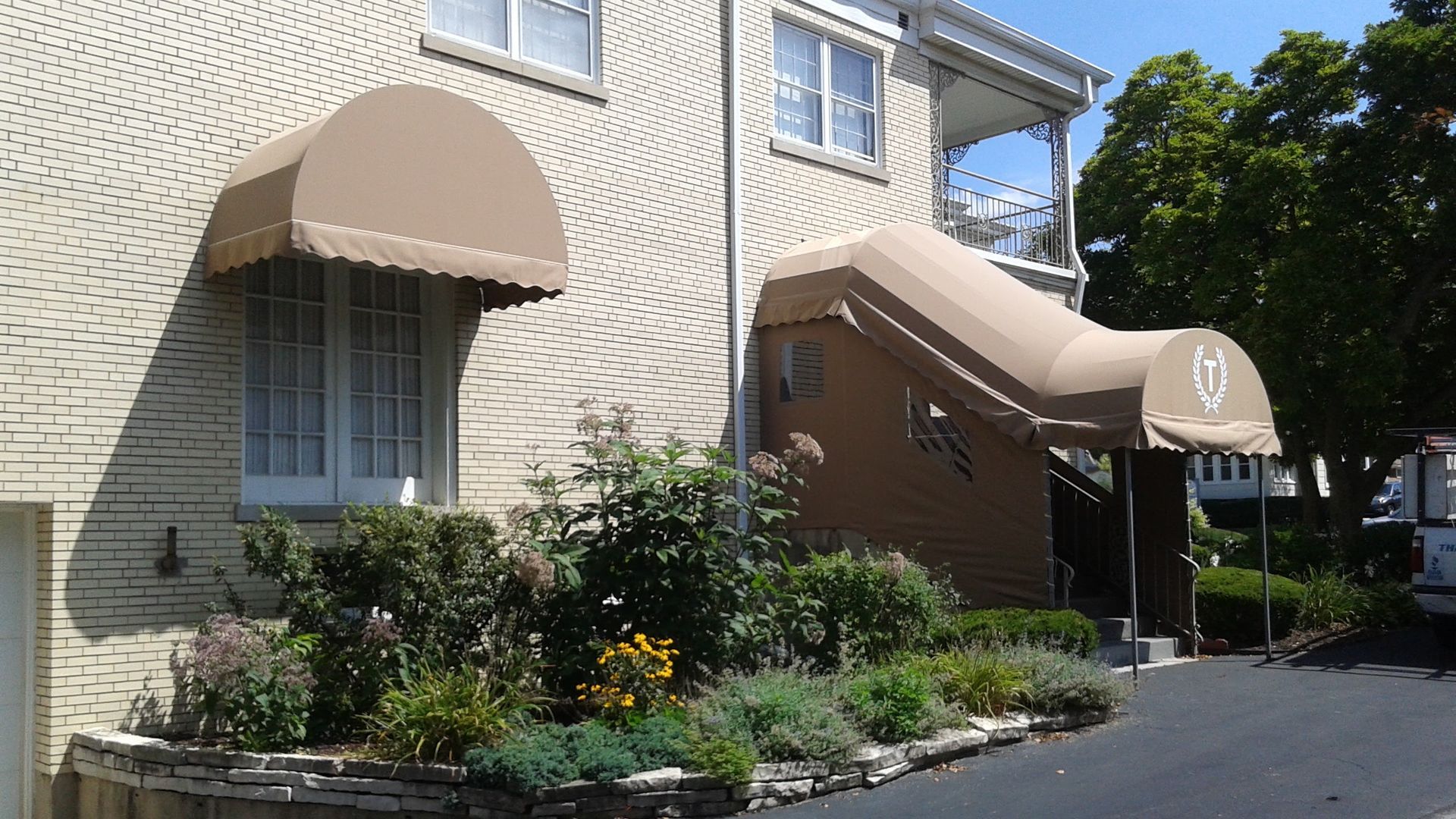 A house with two awnings on the side of it