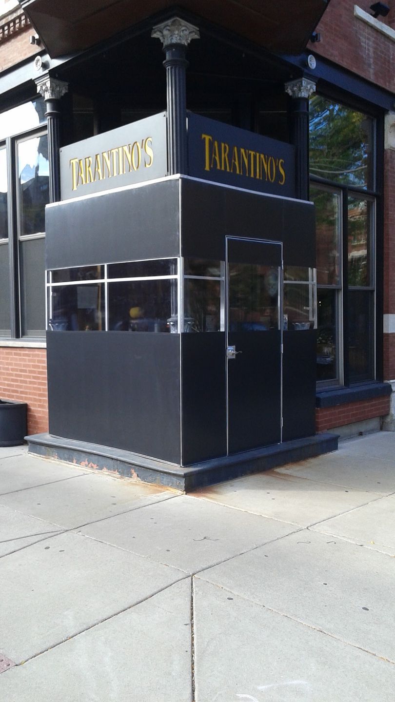 A black building with a sign that says tarantino 's on it