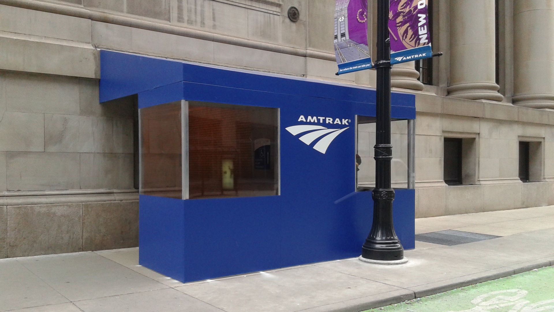 A blue awning with the word amtrak on it