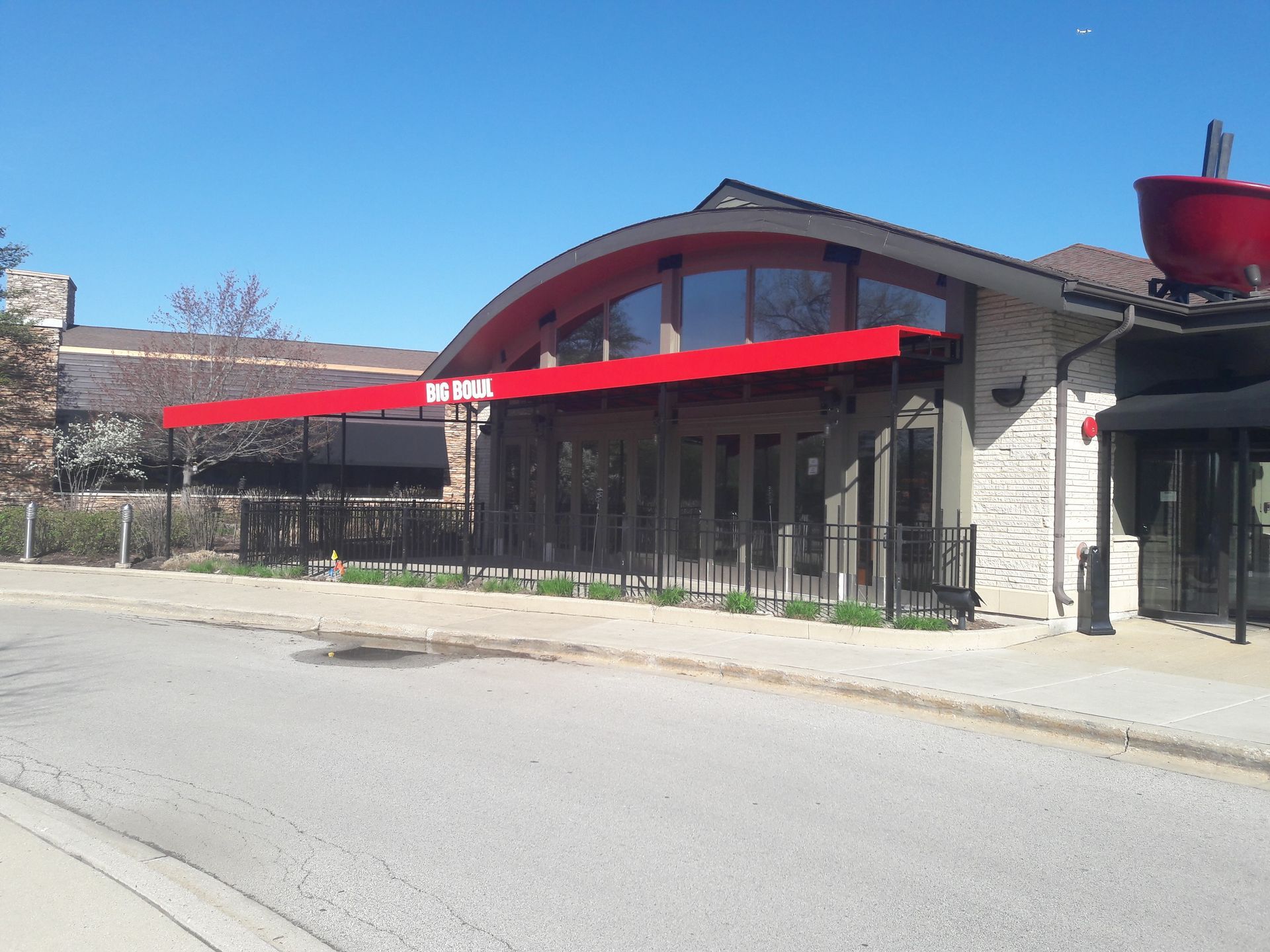 A large building with a red awning on top of it