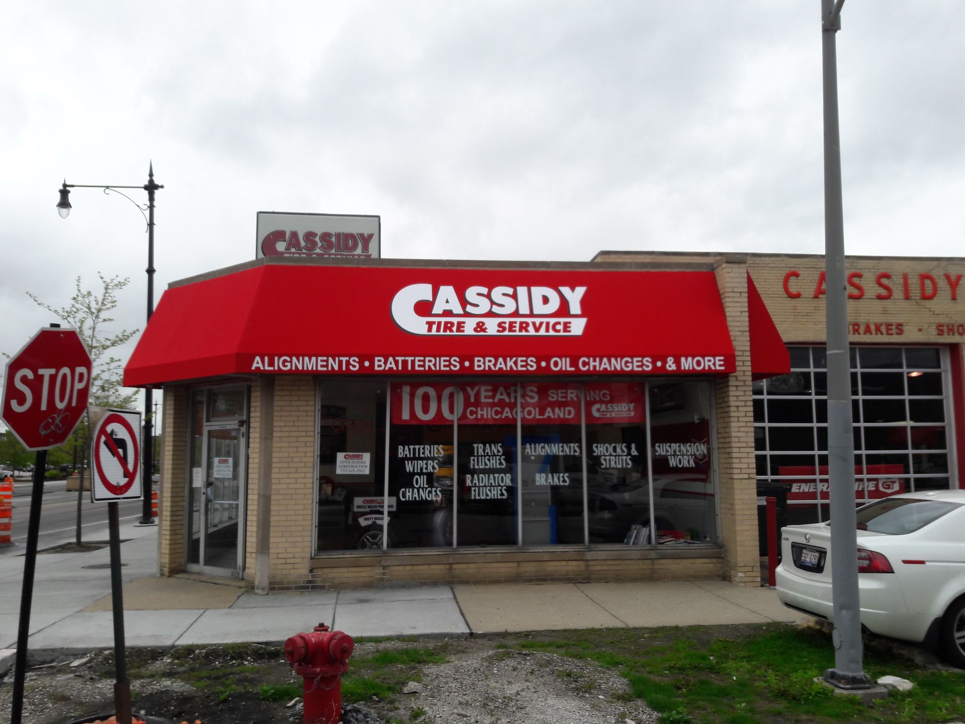 A red awning over a cassidy tire and service store