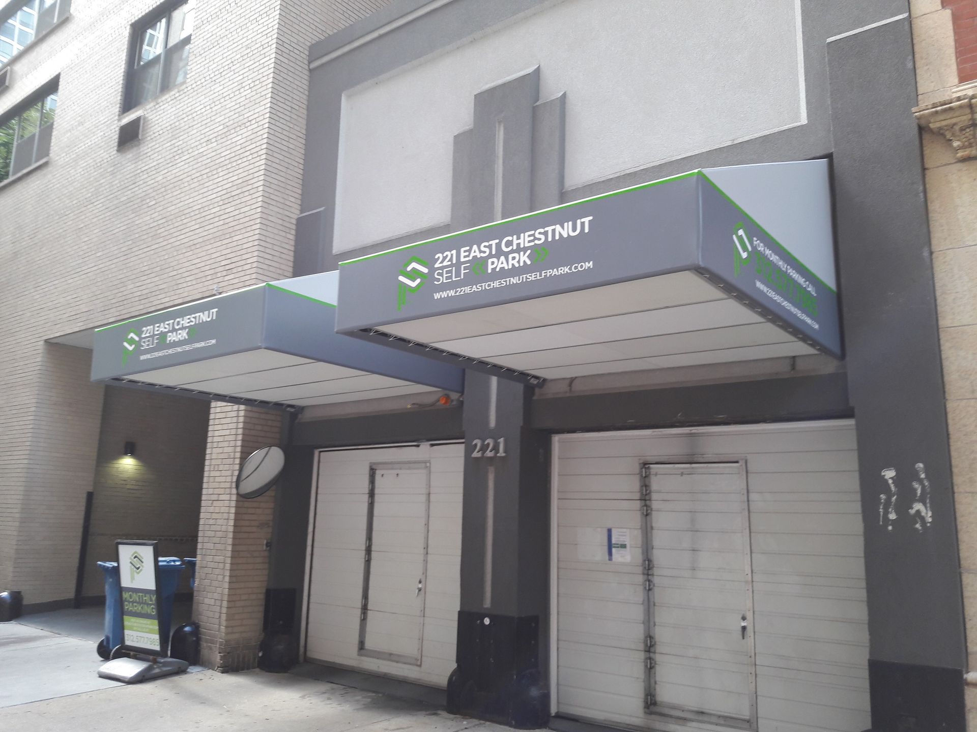 A building with a canopy over the entrance and the number 233 on it