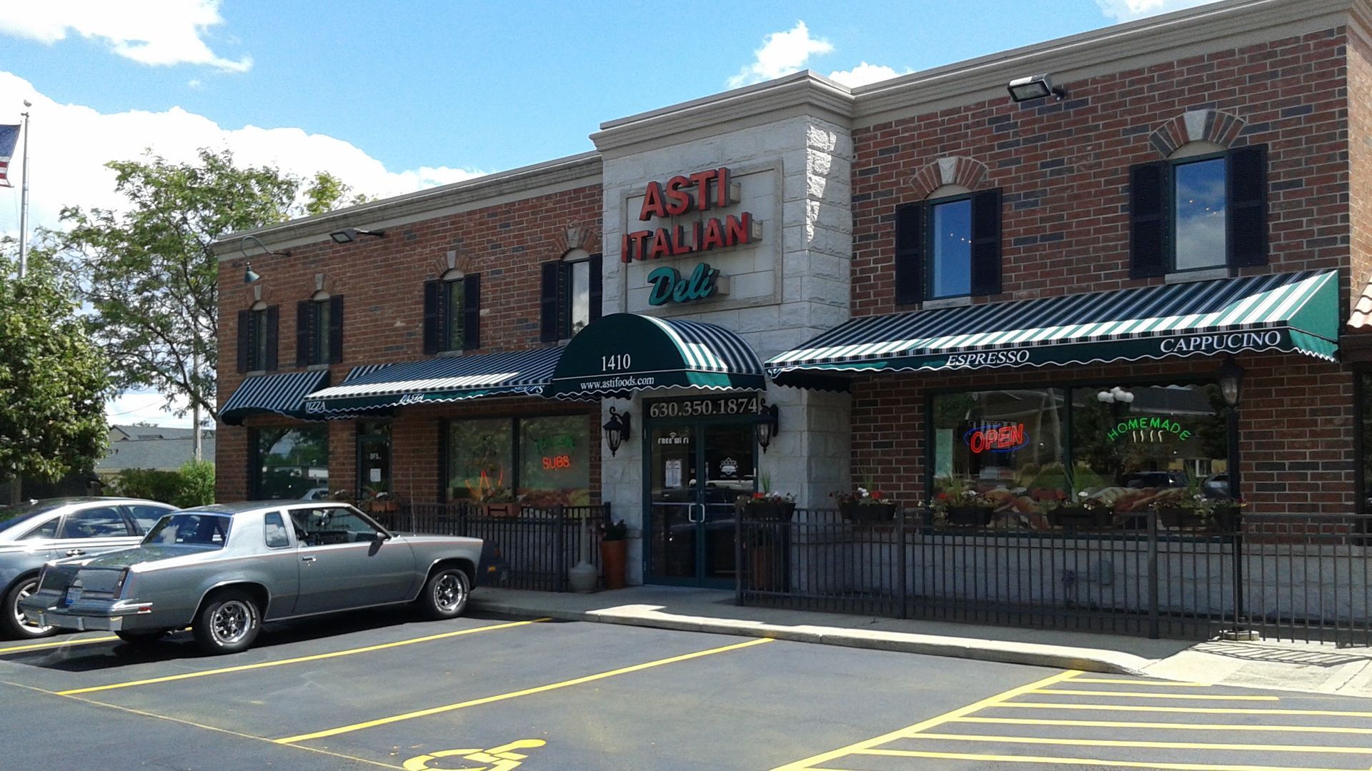 A car is parked in front of an italian restaurant