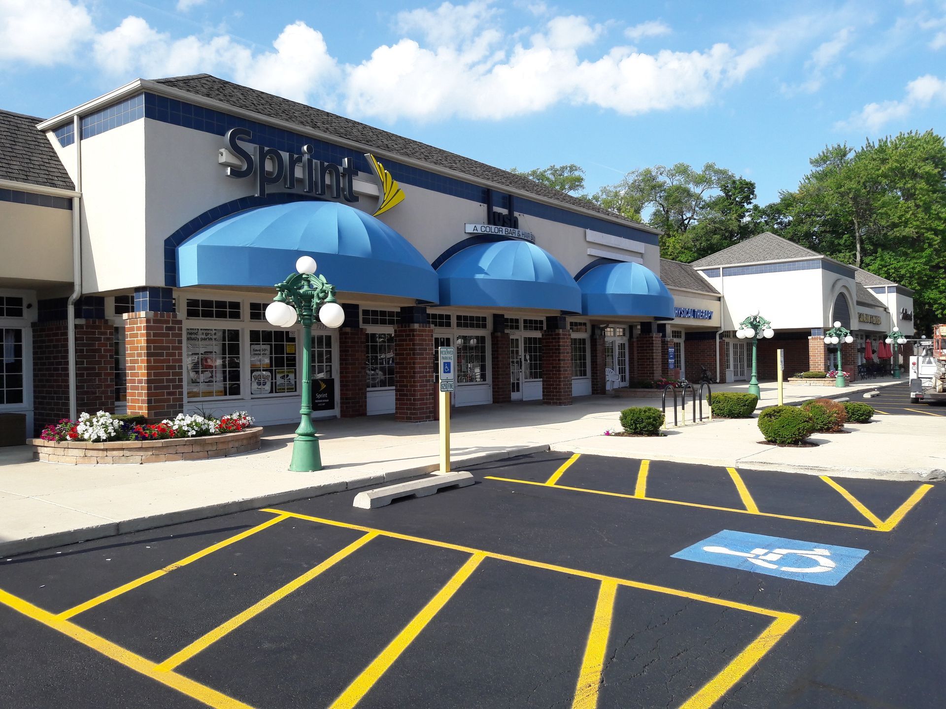 A store front with a handicapped parking space in front of it