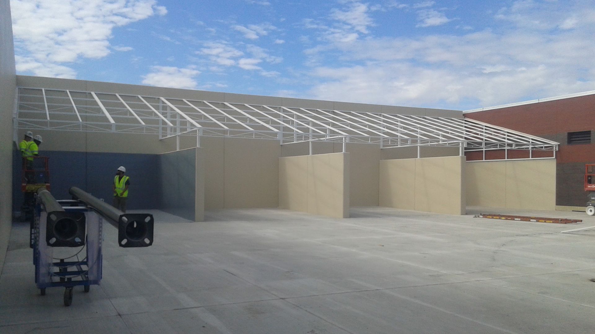 A group of construction workers are working on a building.