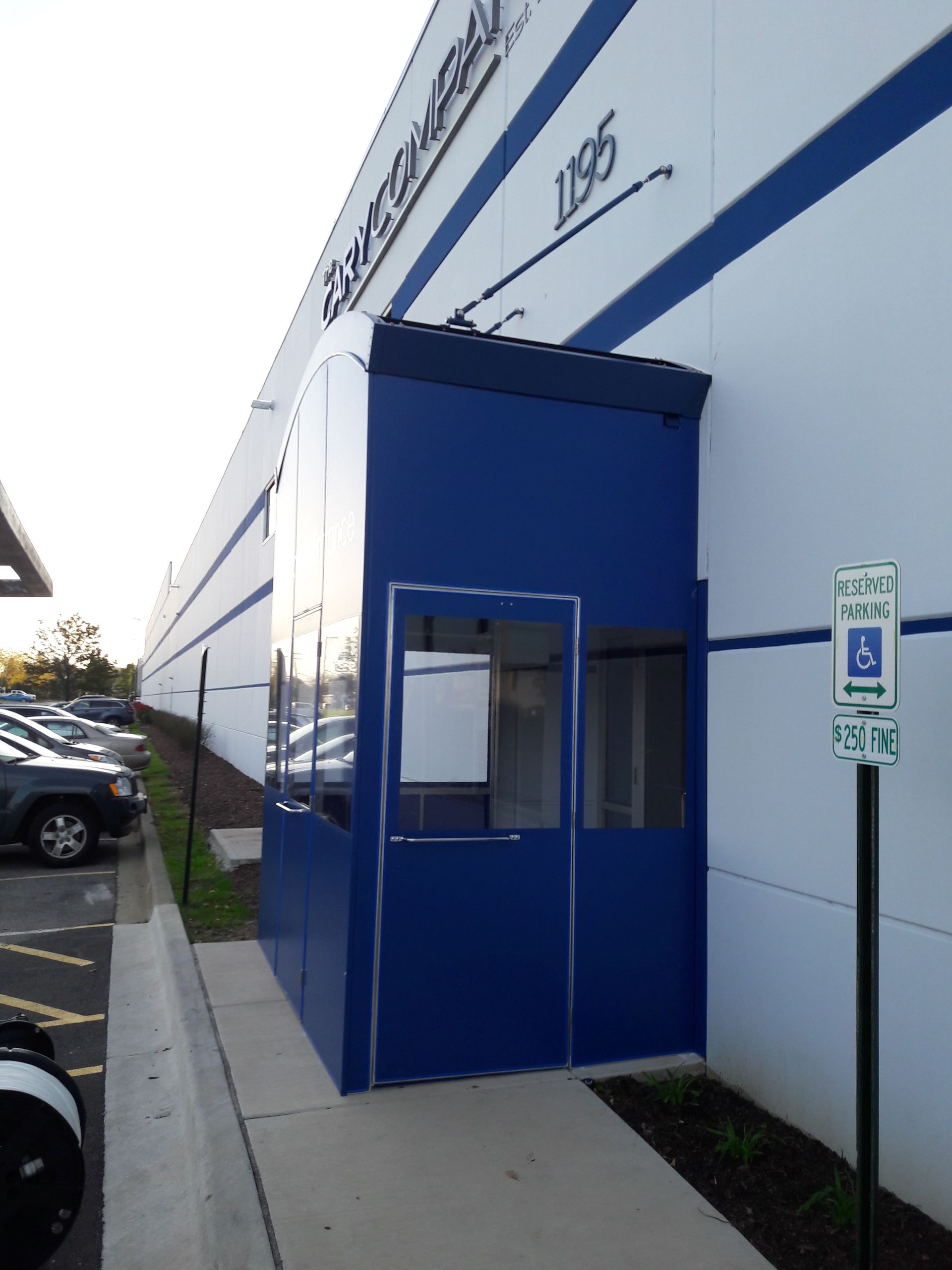 A blue building with a handicapped parking sign in front of it