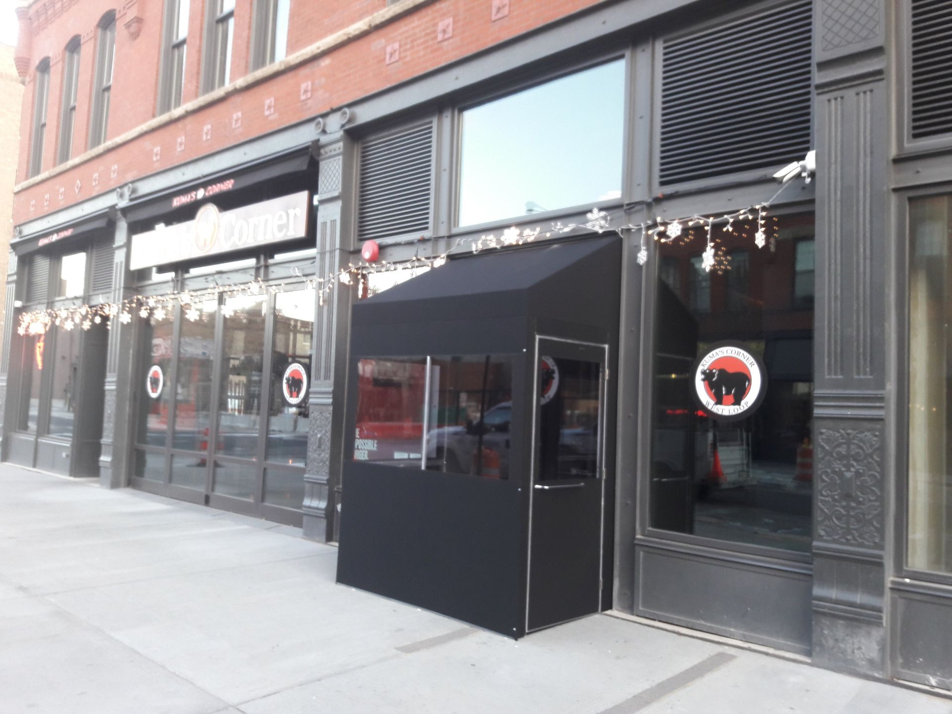 A building with a black awning on the side of it