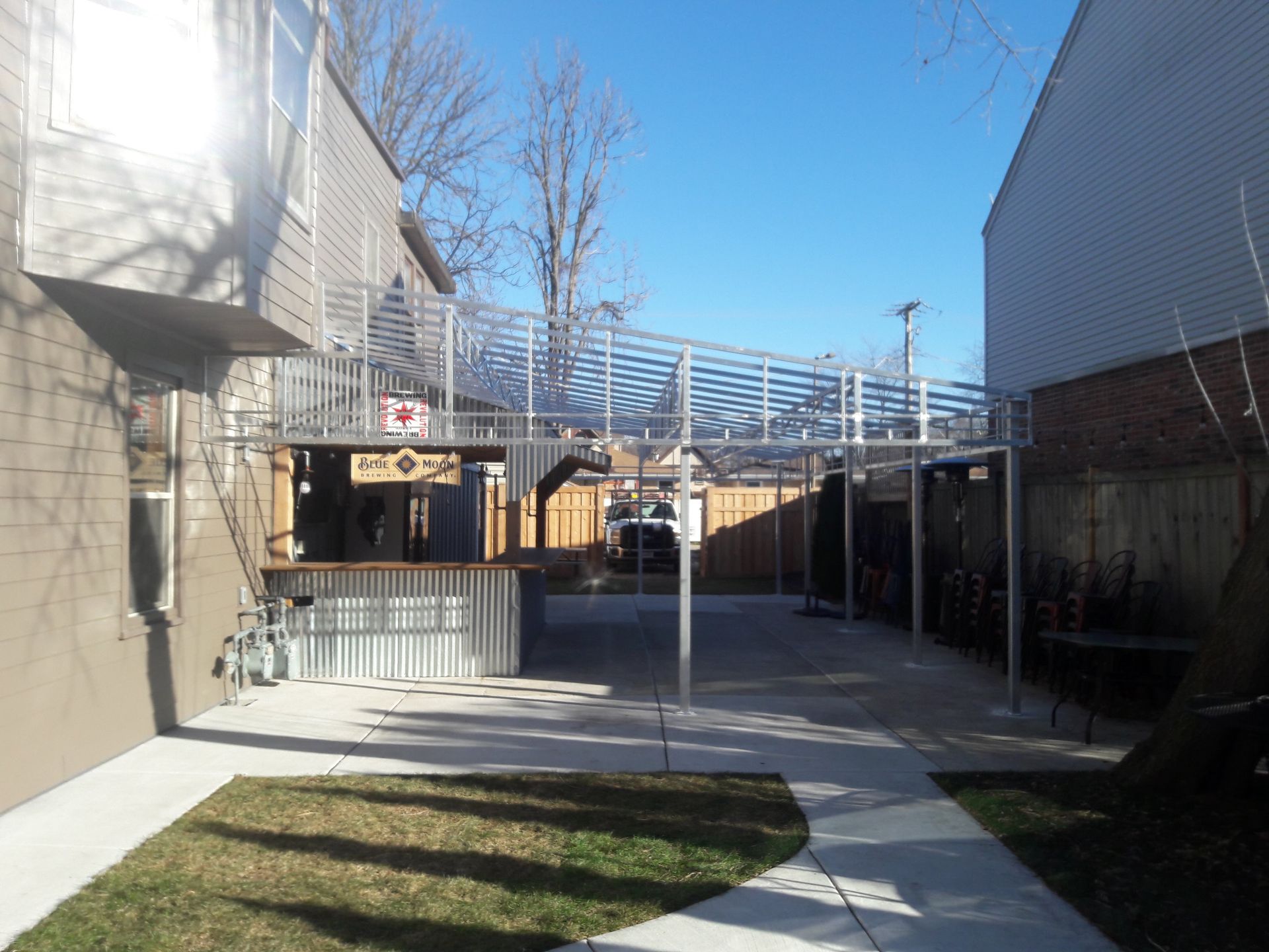 A walkway between two buildings with a sign that says no parking