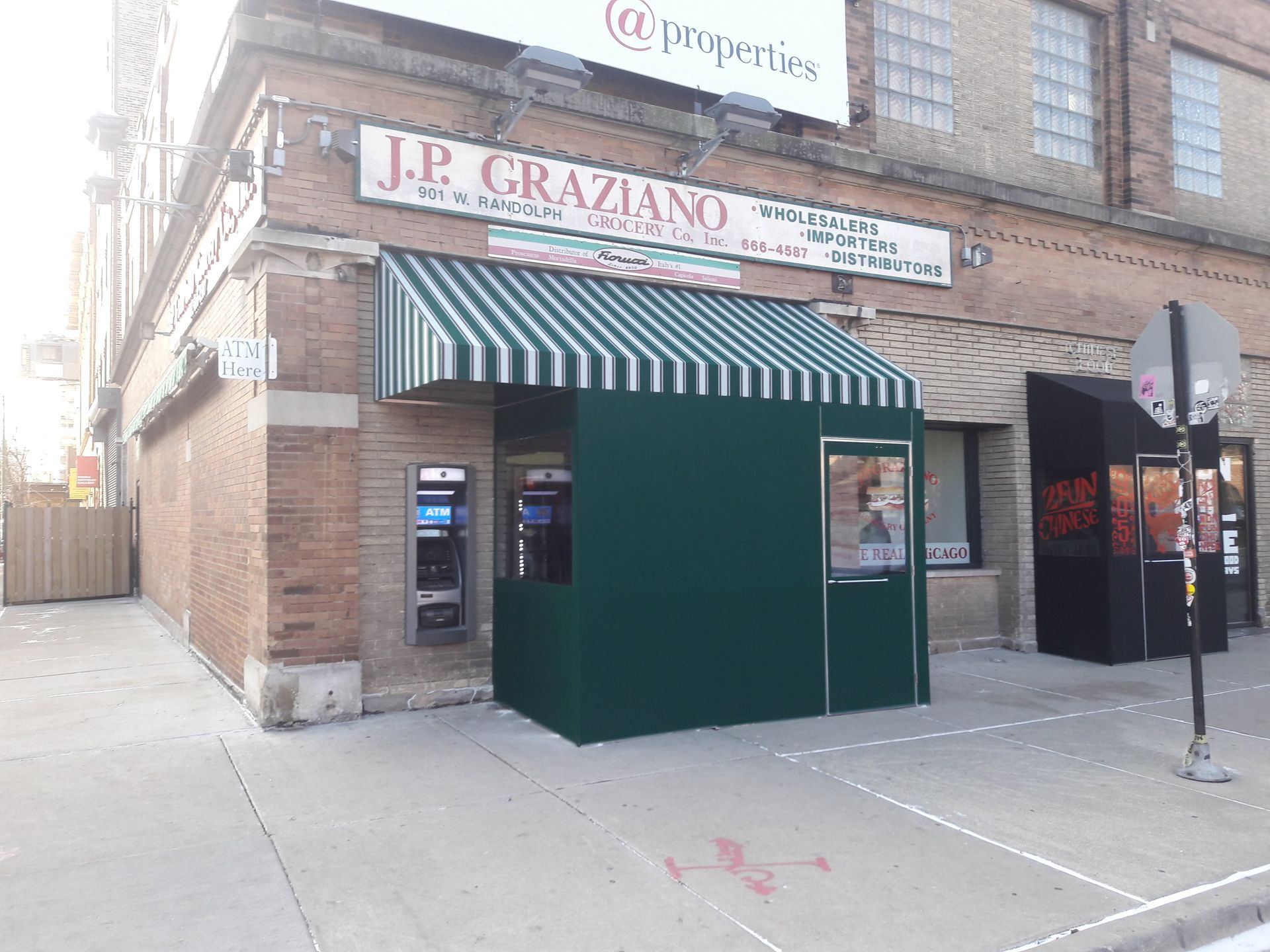A building with a green awning and a sign that says j.p. graziano