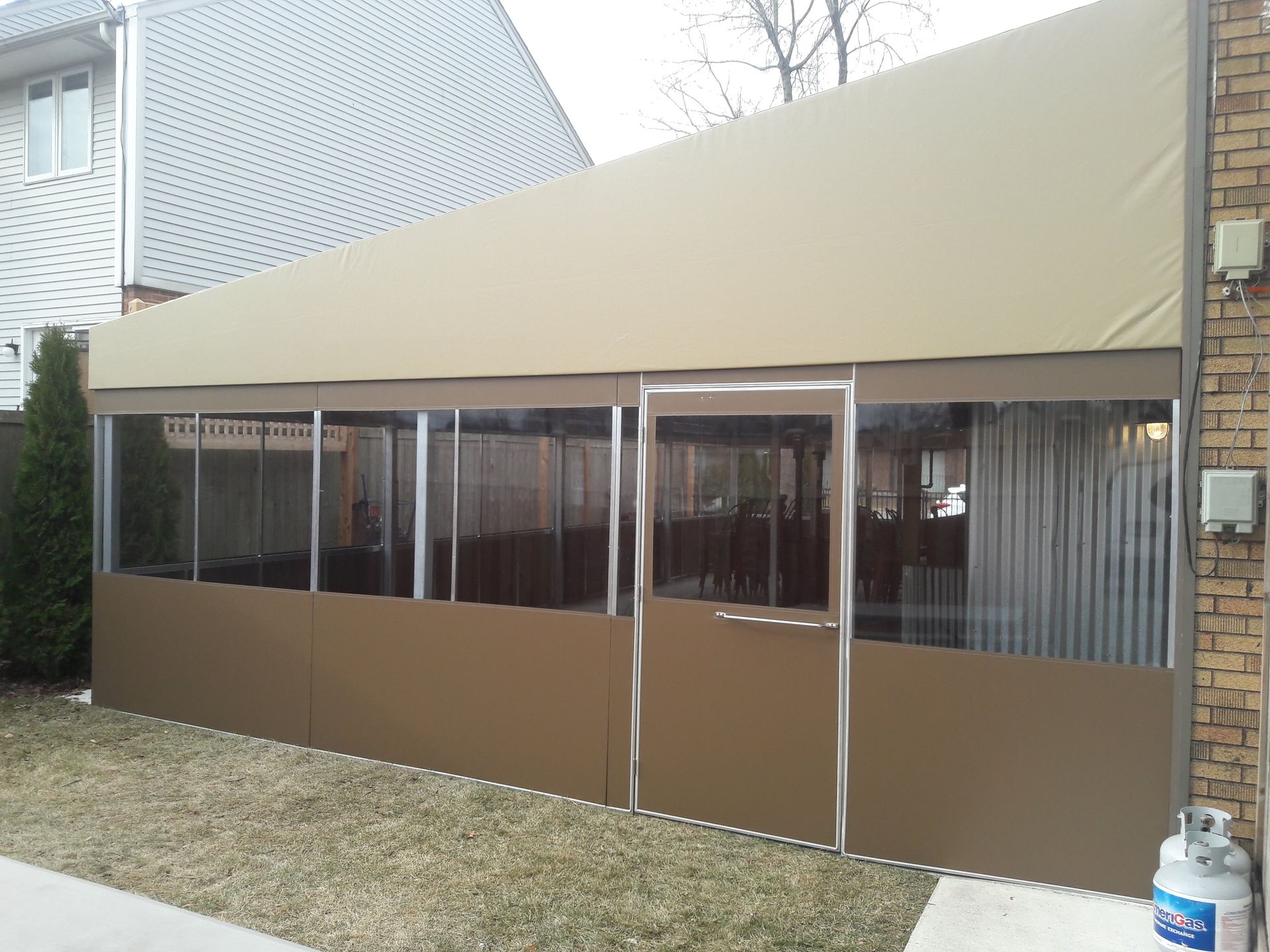 A house with a large tent on the side of it