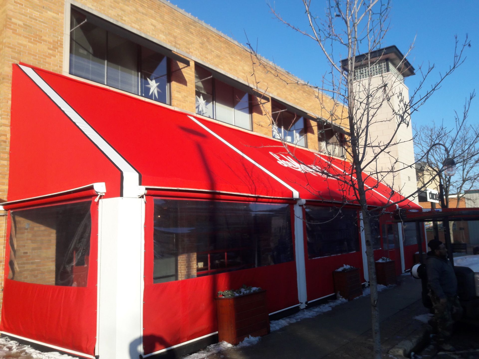 A red awning is on the side of a building
