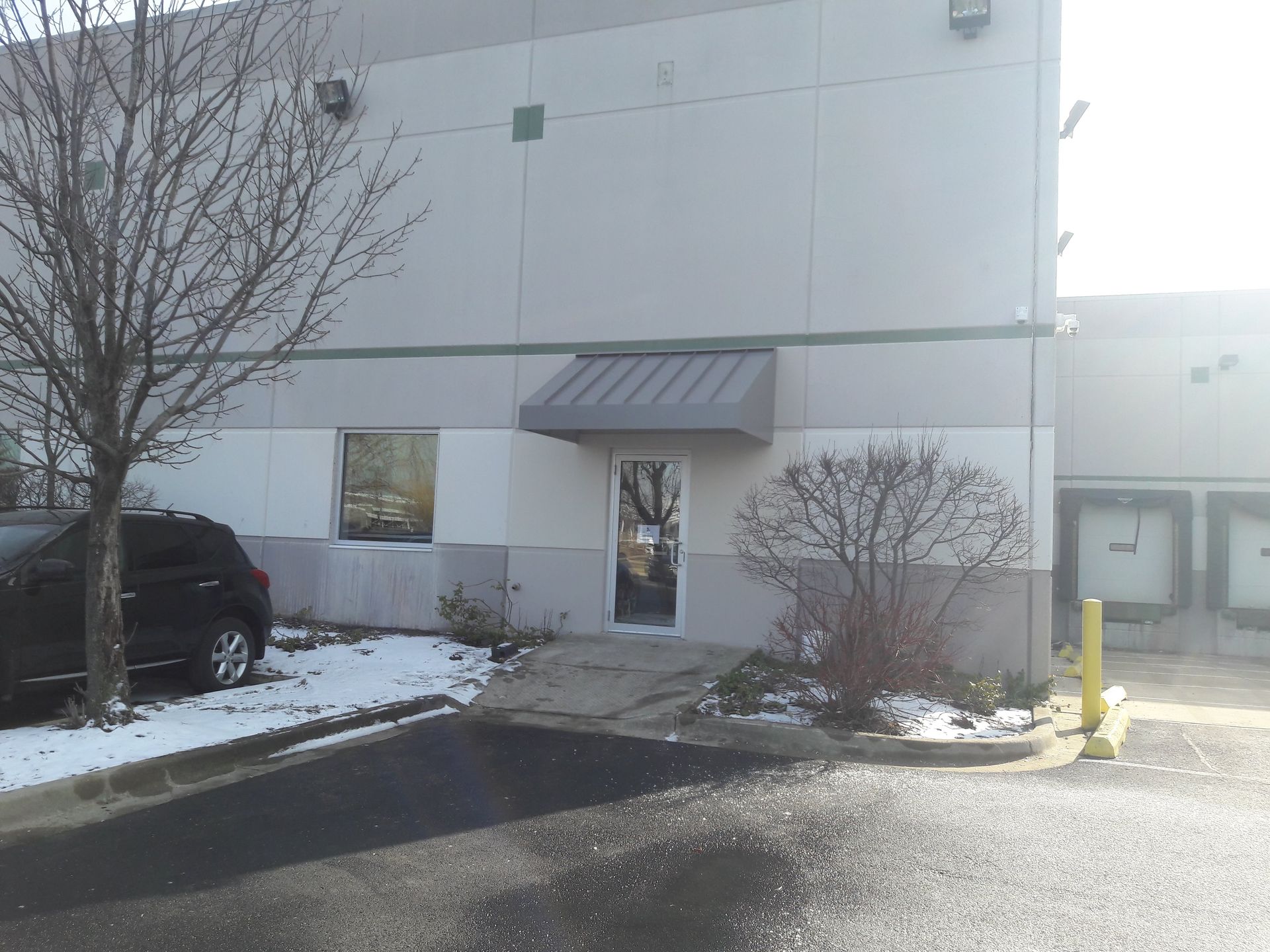 A building with a car parked in front of it
