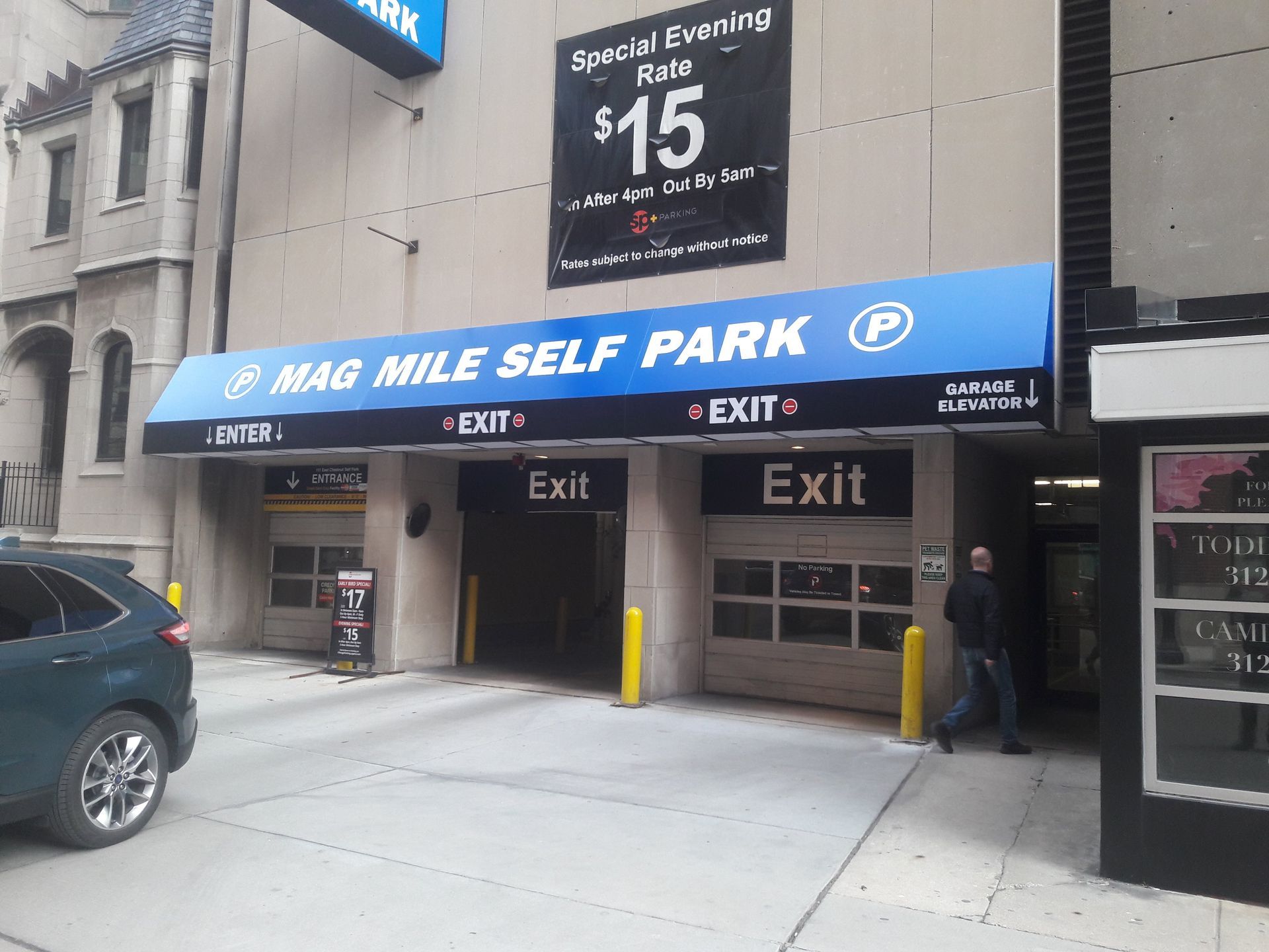 A parking garage with a blue awning that says mag mile self park