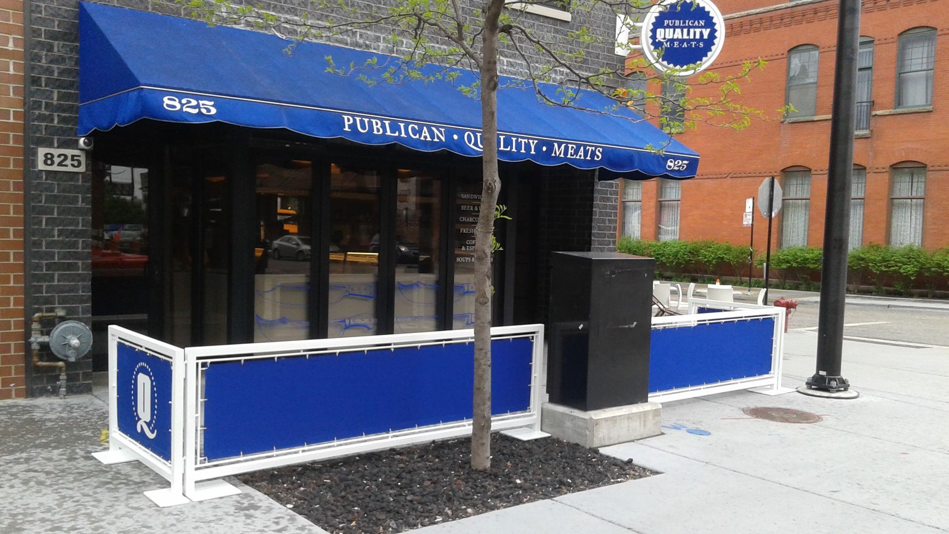 A blue awning with the word budweiser on it