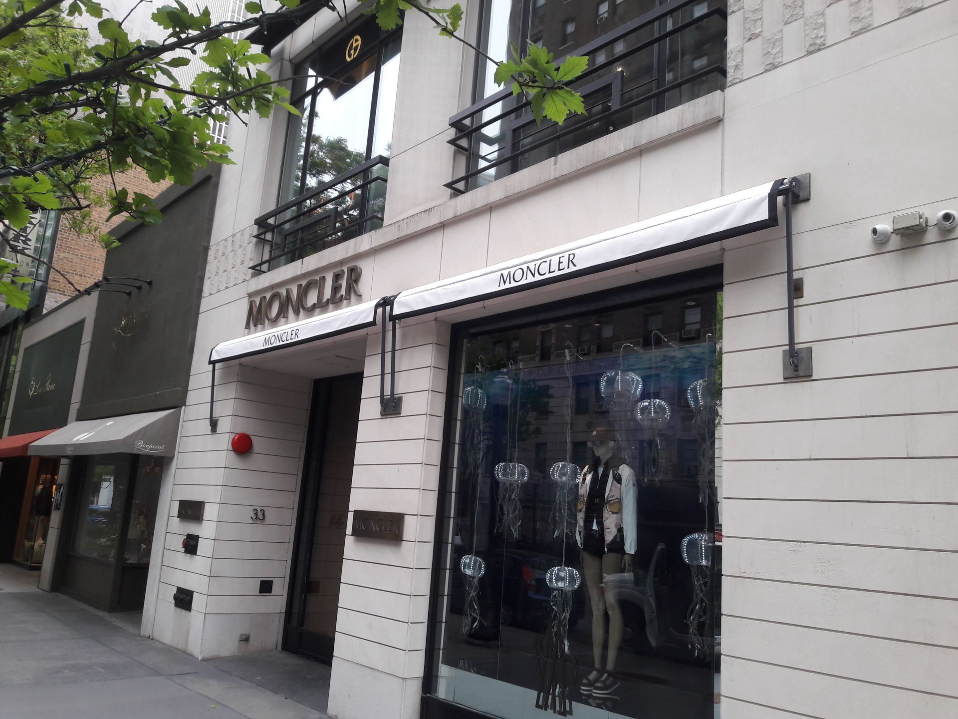 A store front with a white awning that says moncler