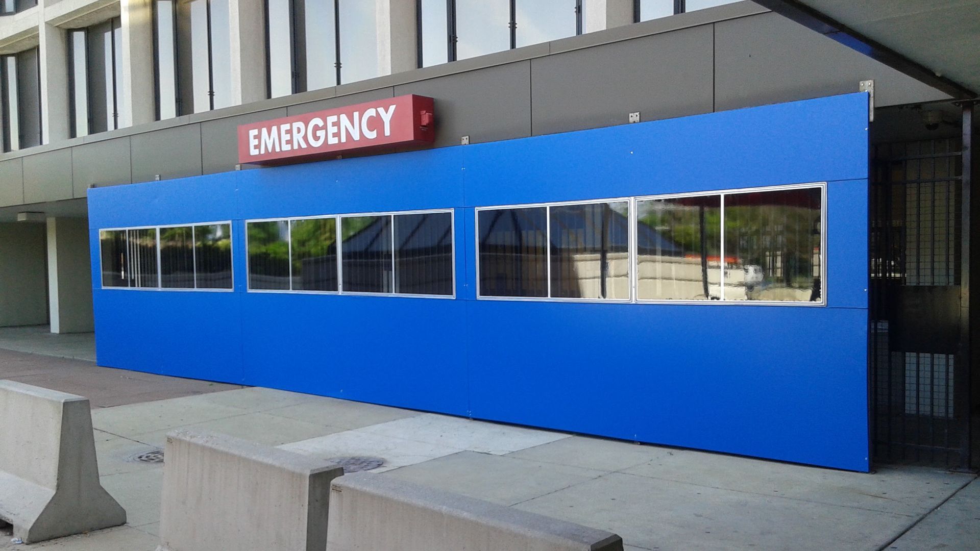 A blue building with a red sign that says emergency
