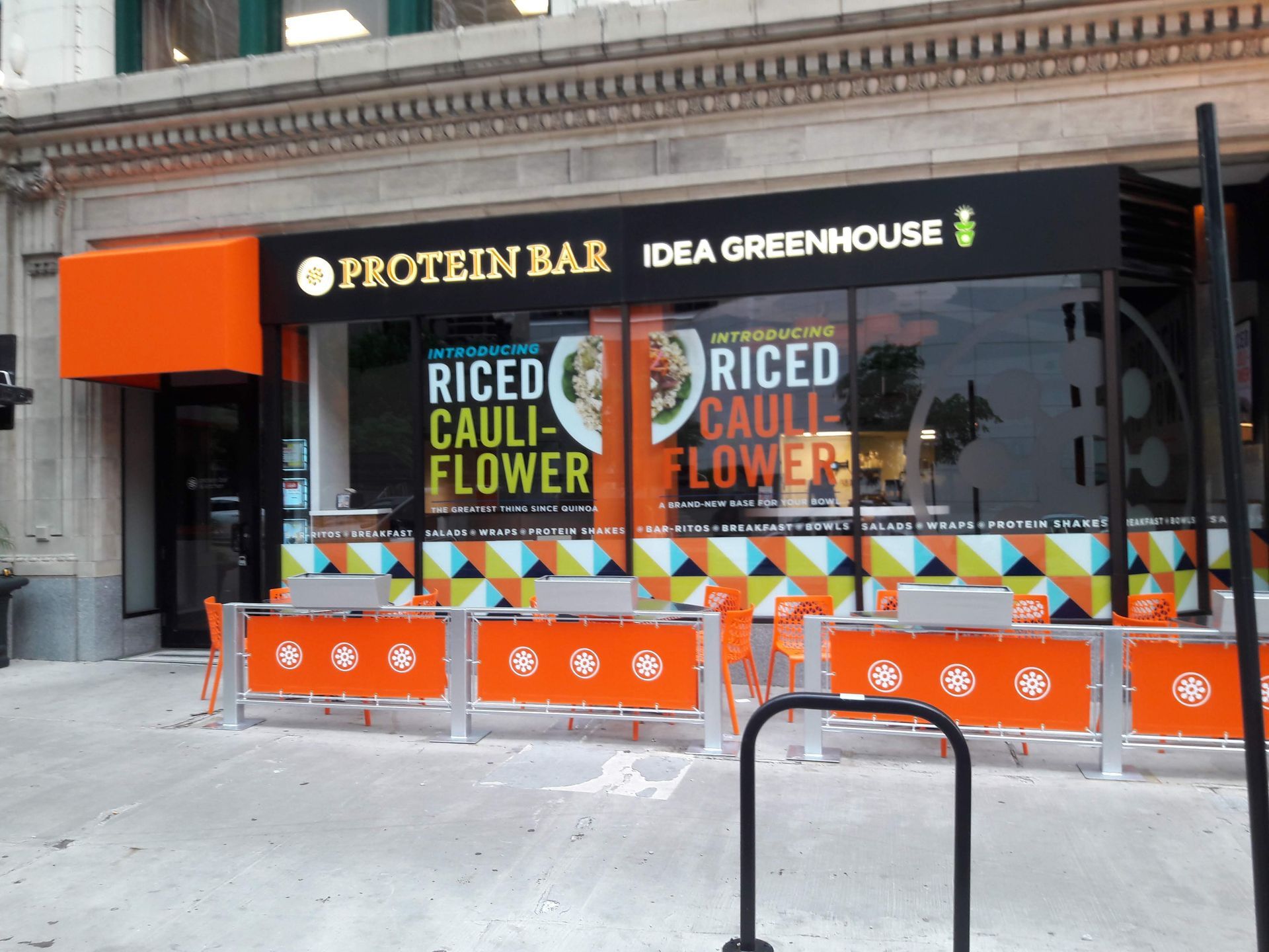 The outside of a protein bar with a sign that says riced cauliflower